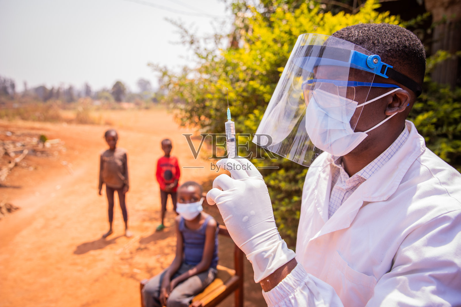 一名非洲医生即将为儿童接种预防冠状病毒感染的疫苗。非洲的疫苗接种概念照片摄影图片