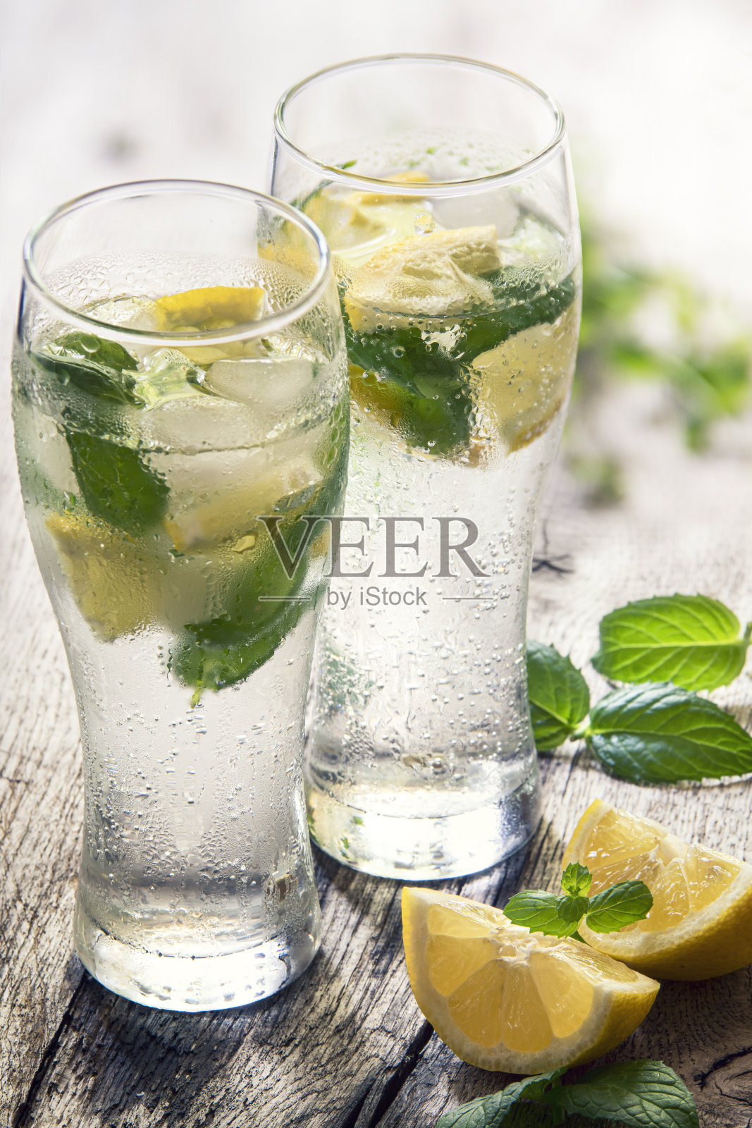 在玻璃杯中加入冷水、柠檬和薄荷照片摄影图片