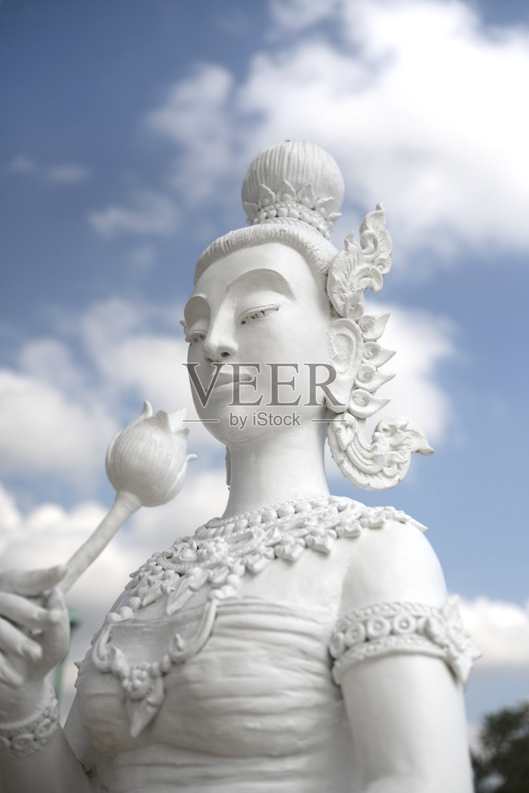 在泰国的寺庙里，天使雕像以蓝天为背景照片摄影图片