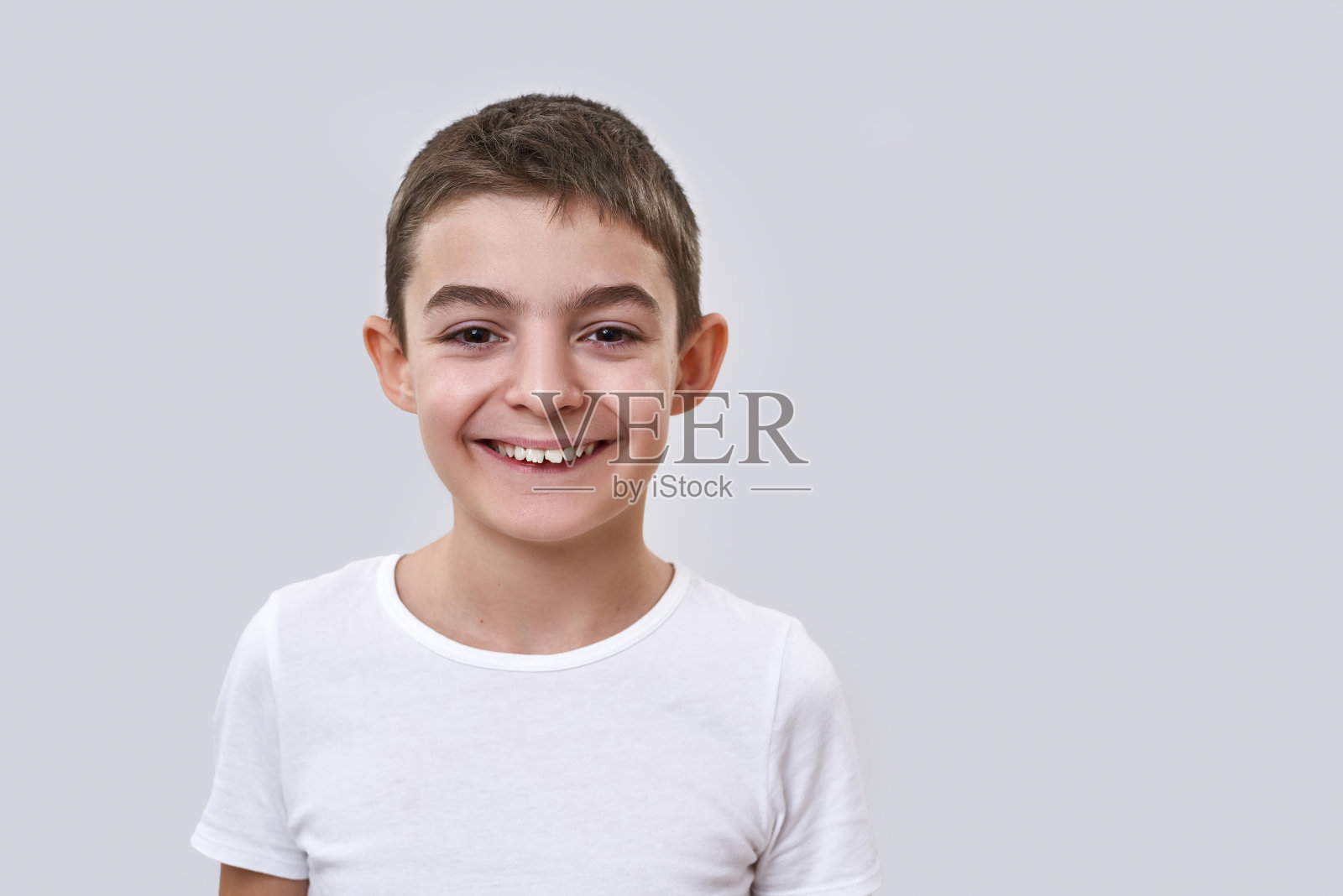 微笑的白人小男孩看着相机照片摄影图片