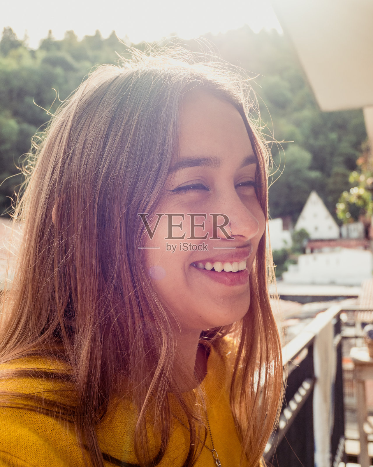 迷人的年轻女孩在阳台上笑照片摄影图片