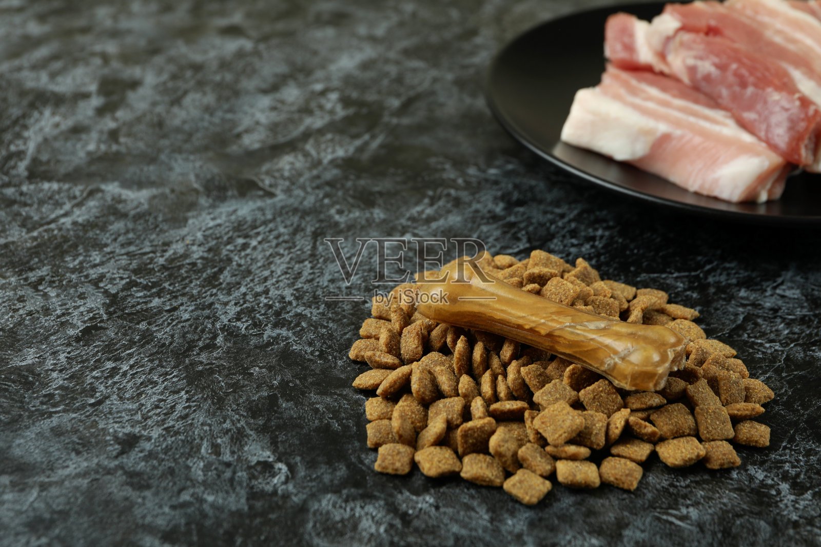 黑色烟熏背景上的天然宠物食品的概念照片摄影图片