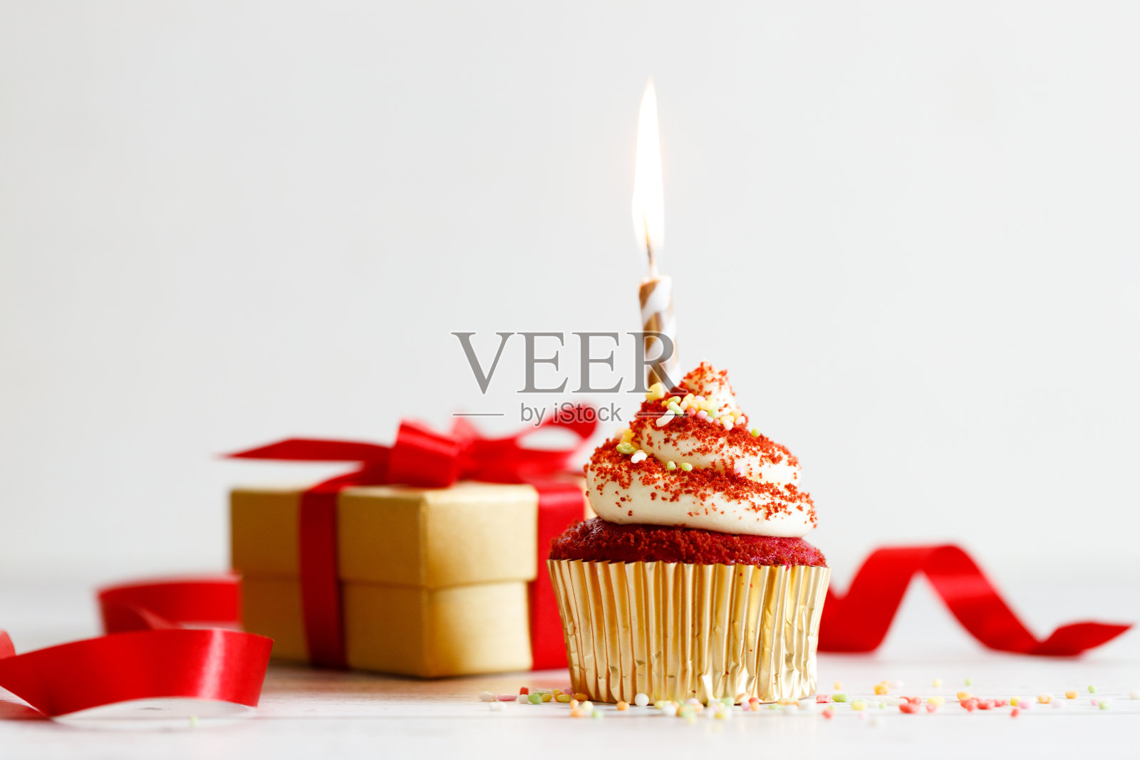 红色丝绒纸杯蛋糕，上面有白色奶油奶酪糖霜。照片摄影图片