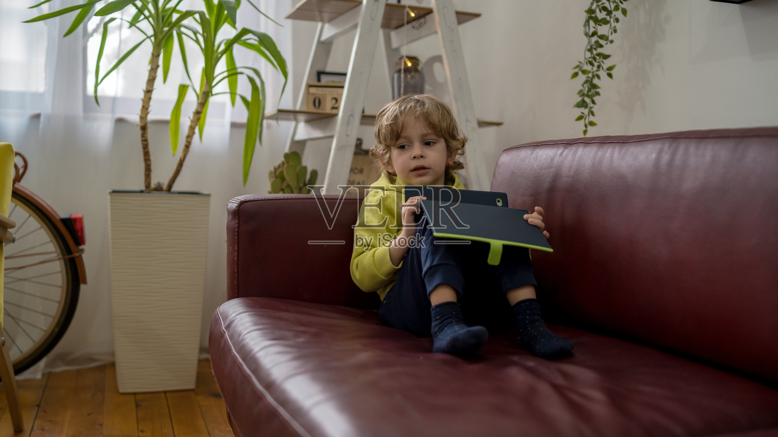 小男孩正在使用平板电脑照片摄影图片