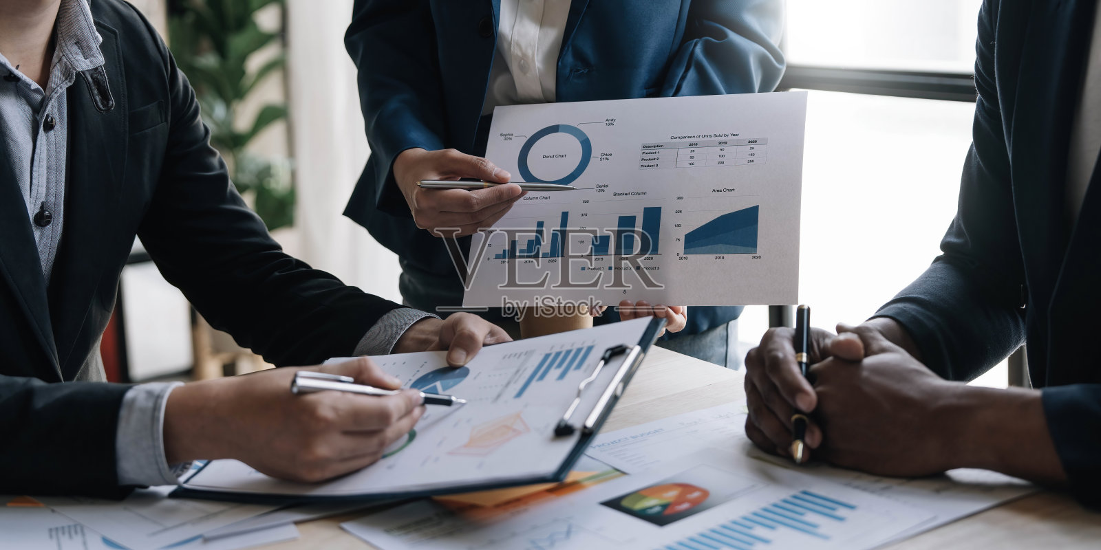 业务财务，会计与合作伙伴正在开会审核财务计划销售，以满足明年设定的目标。股票市场概念。照片摄影图片