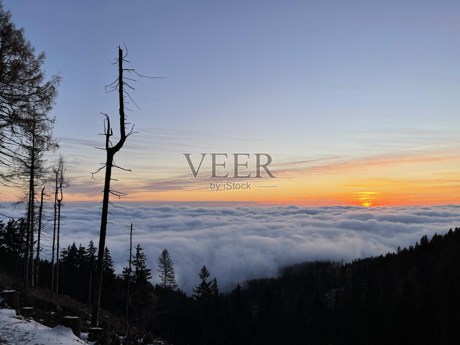 夕阳从云海的山上落下。照片摄影图片
