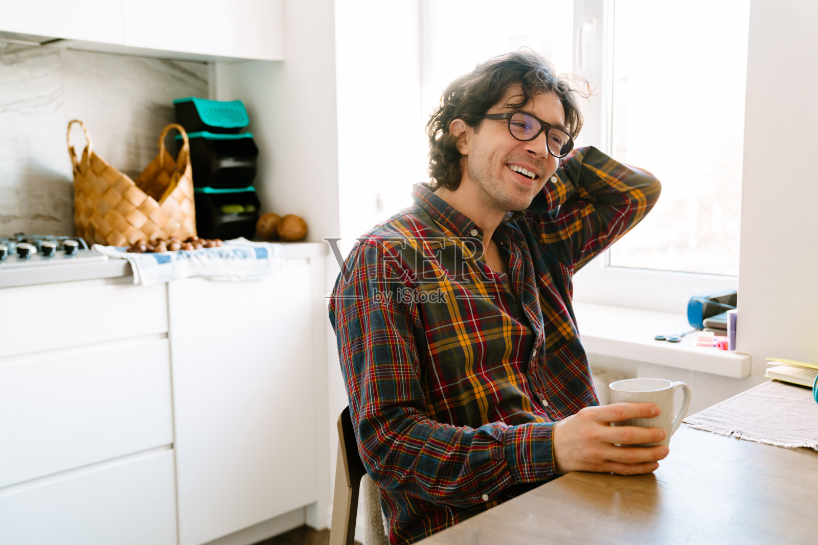 白人坐在厨房里笑着喝咖啡照片摄影图片