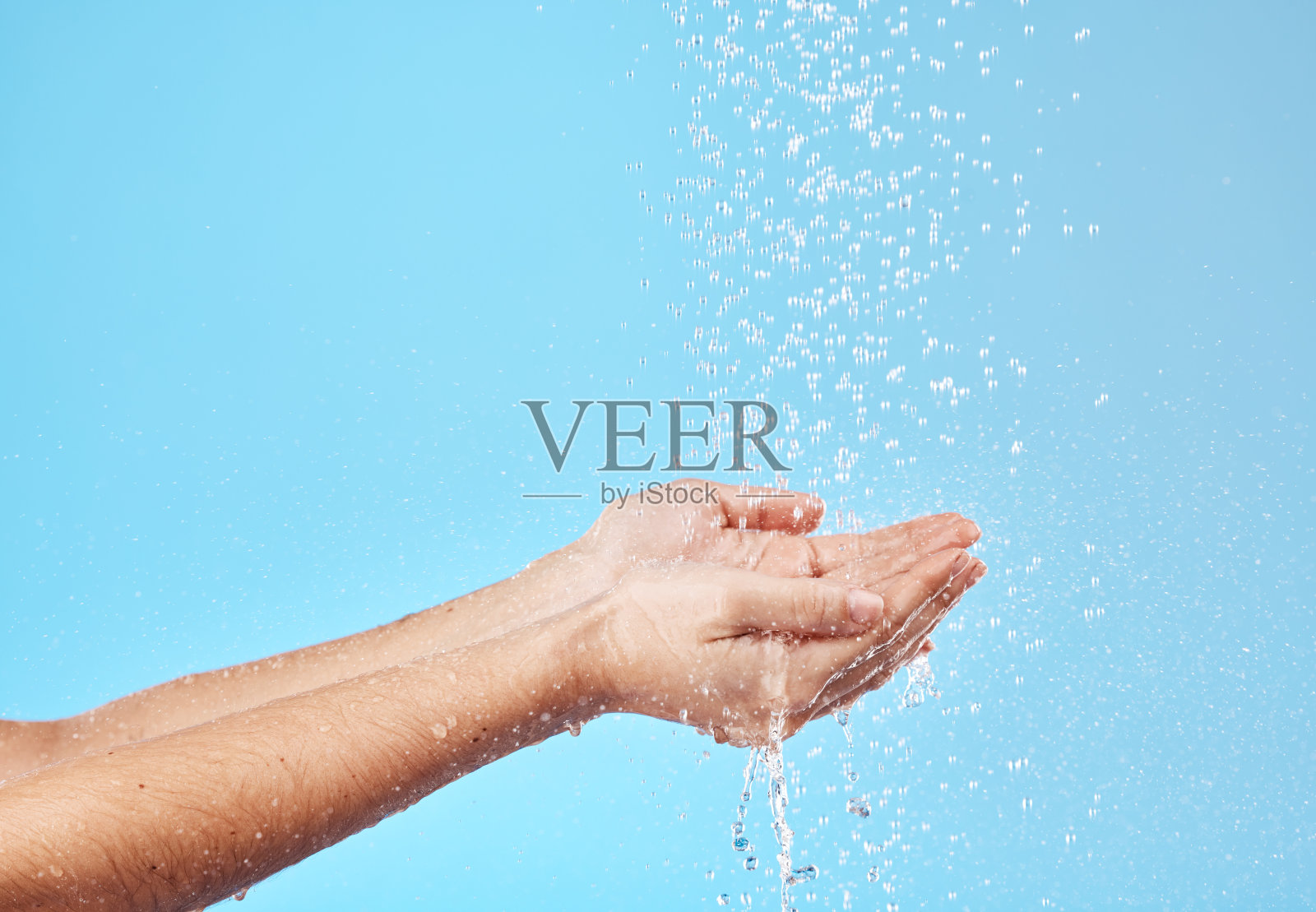 淋浴，水和一个女人的手清洁，节省和捕捉液体对蓝色的工作室背景。可持续性，健康和照顾身体的人，美容和卫生与模型空间照片摄影图片