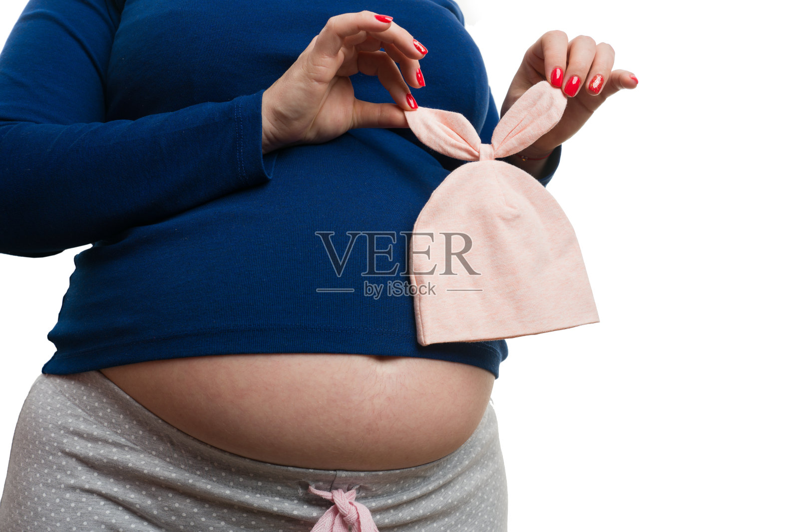 特写孕妇抓婴儿粉红色的哈尔与细节照片摄影图片