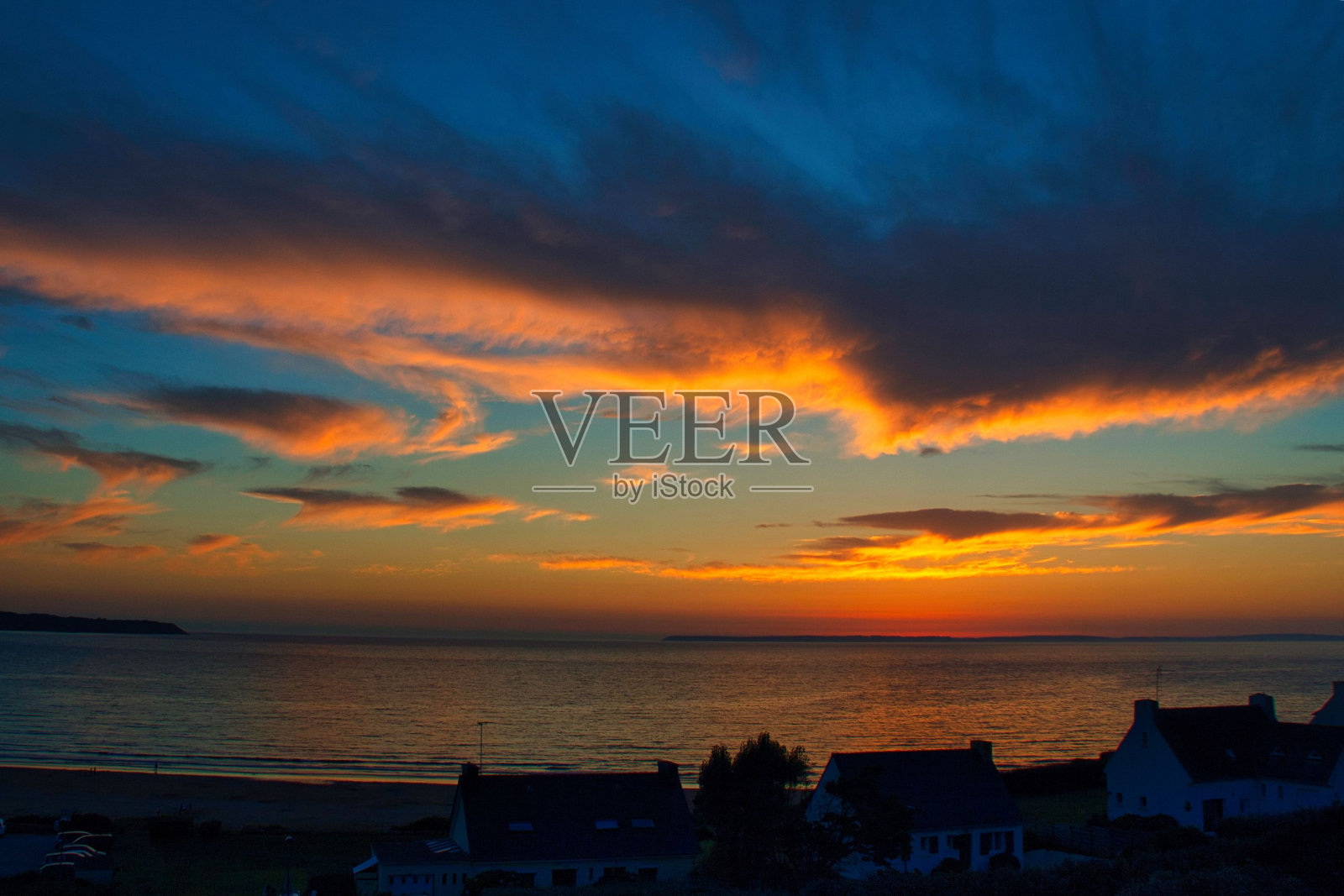 在法国布列塔尼的普洛内维斯-波尔扎伊海滩上，大西洋上空的史诗般的日落照片摄影图片