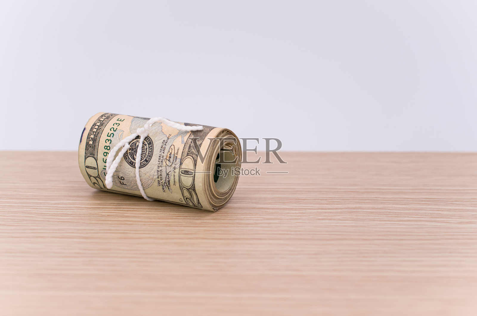 孤立的美元纸币滚动在木制背景与复制空间照片摄影图片