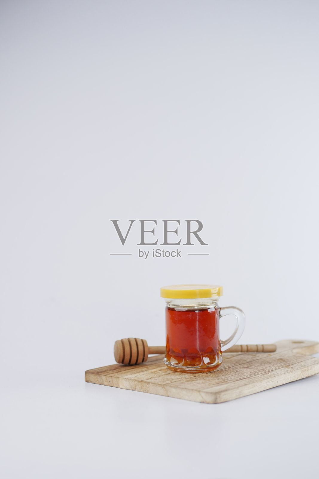 新鲜的蜂蜜在玻璃罐中隔离在白色上照片摄影图片