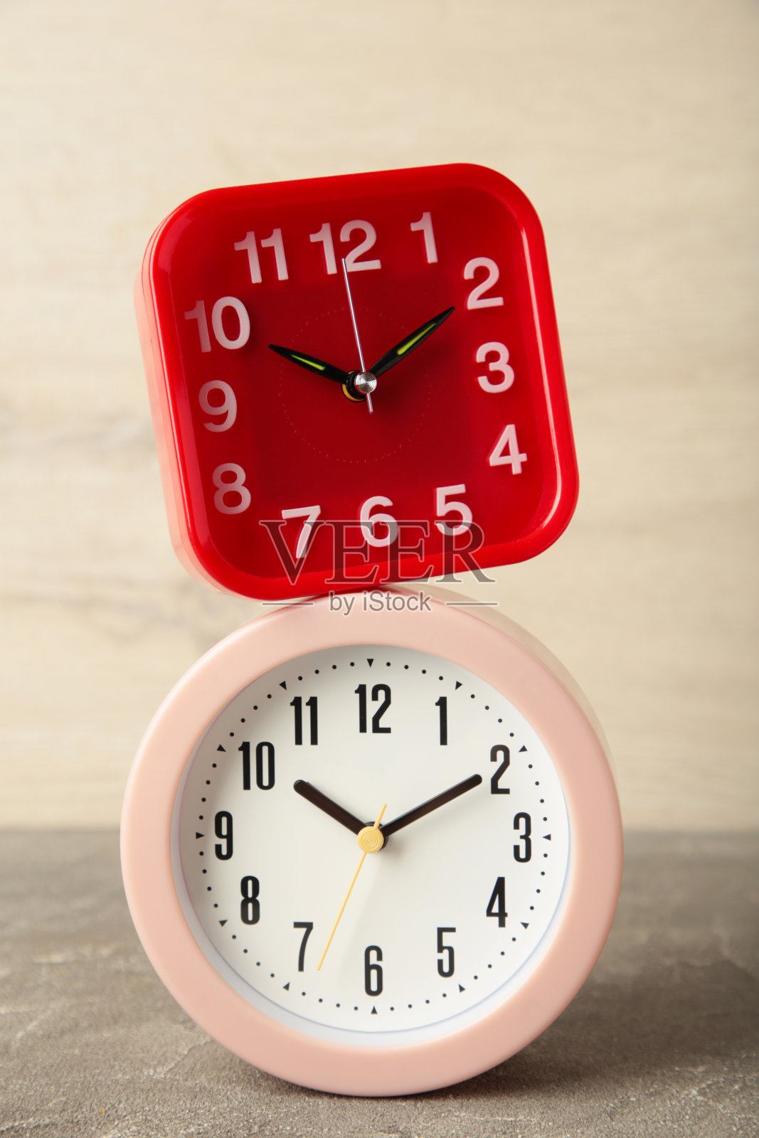 粉色和红色闹钟在灯光背景。前视图。照片摄影图片