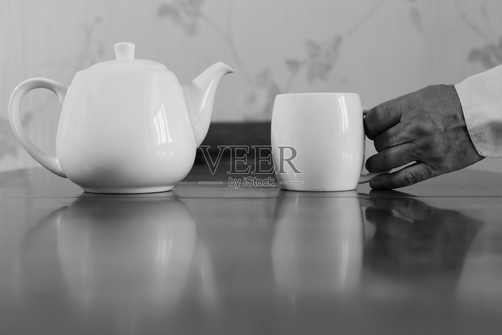 白色陶瓷茶壶和白色陶瓷马克杯在一个老人的手中照片摄影图片
