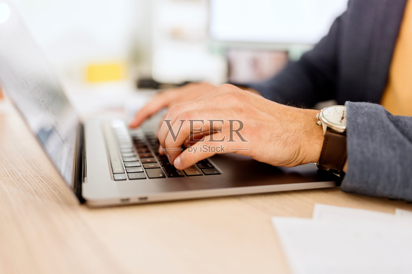 一个男人在他的笔记本电脑上工作的特写照片摄影图片