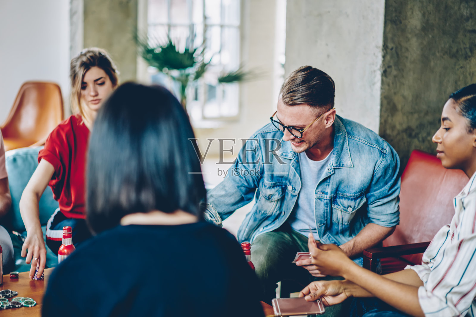 多种族的朋友在公寓打扑克照片摄影图片