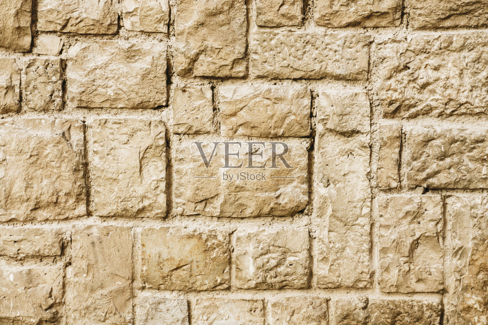 黄色的砖墙。水平装饰不均匀块背景。城市建筑肌理。照片摄影图片