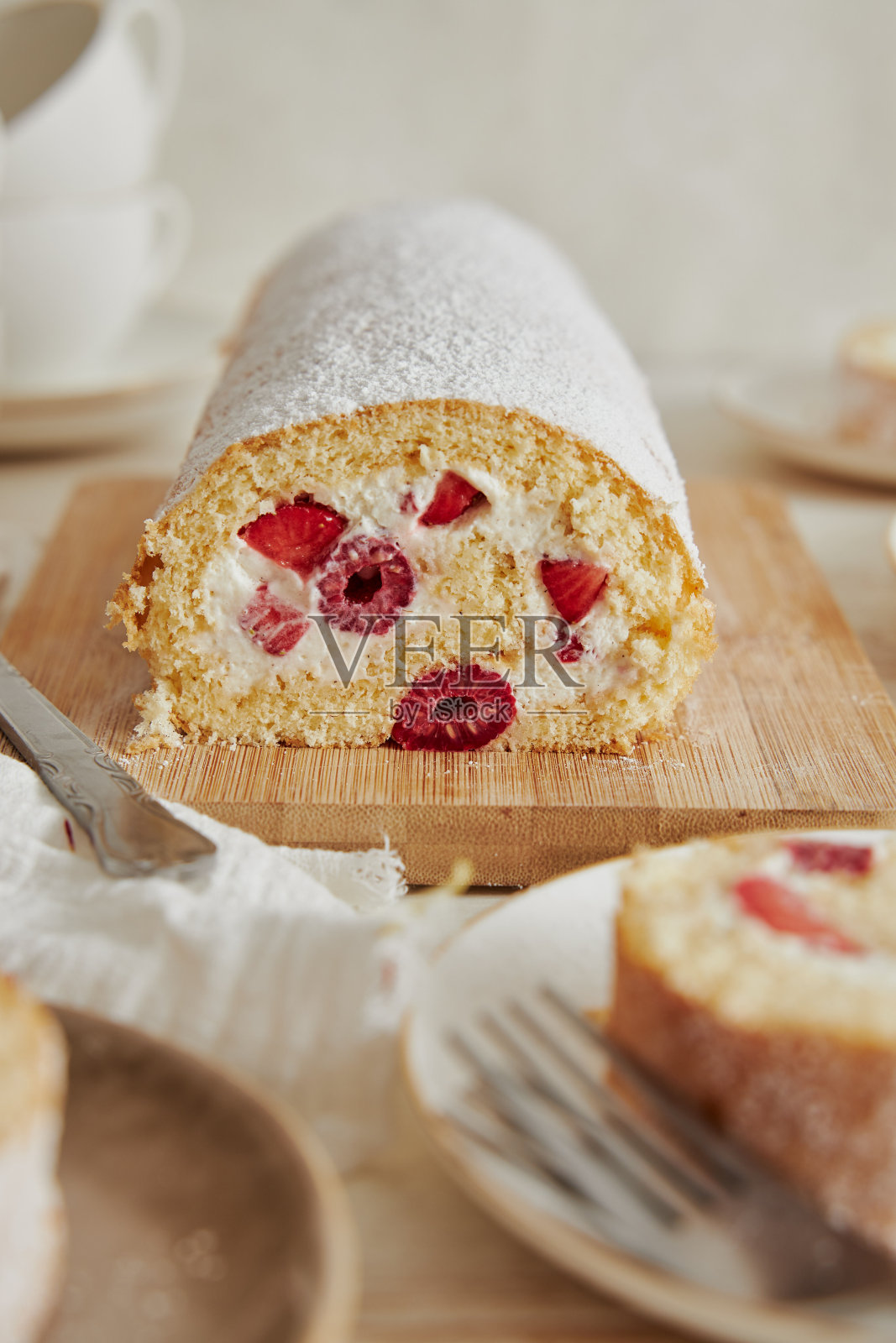 垂直拍摄的美味饼干卷，覆盆子和奶油放在木板上照片摄影图片