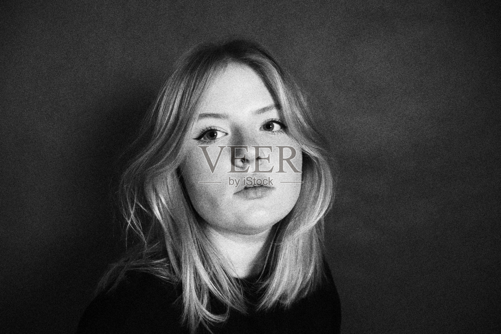 特写镜头在黑色和白色的白人有吸引力，金发女子摆出性感的方式照片摄影图片