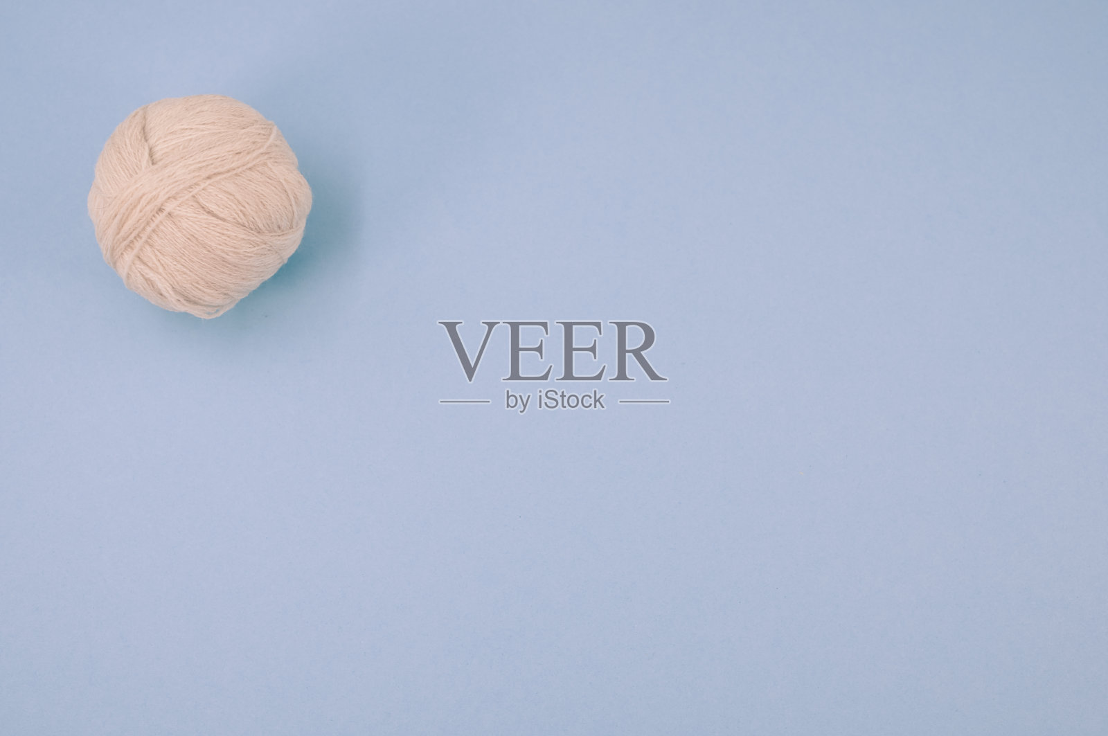 垂直镜头软米色纱球在青色的背景照片摄影图片