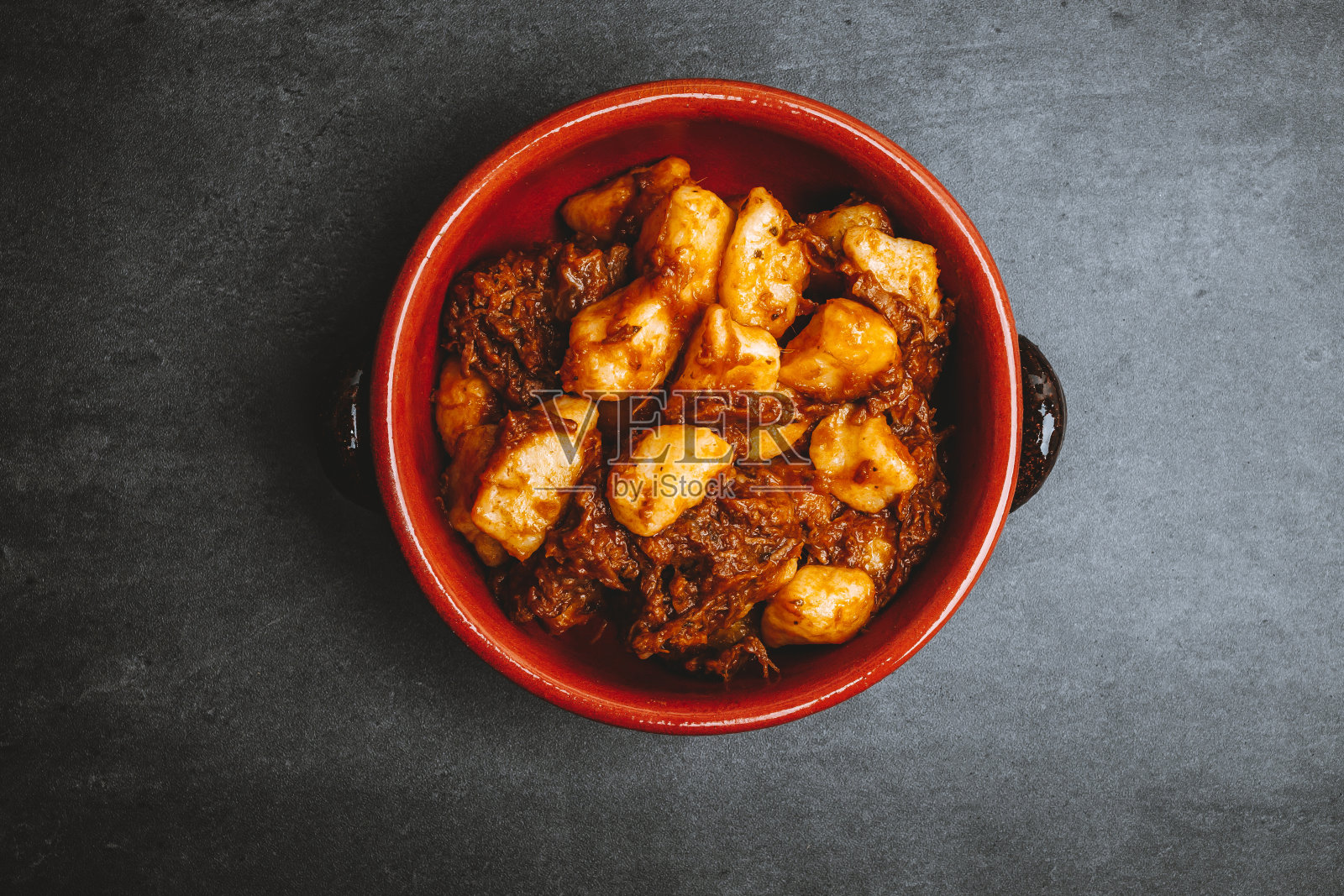 土豆汤圆，意大利土豆饺子，深色背景炖。副本的空间。照片摄影图片