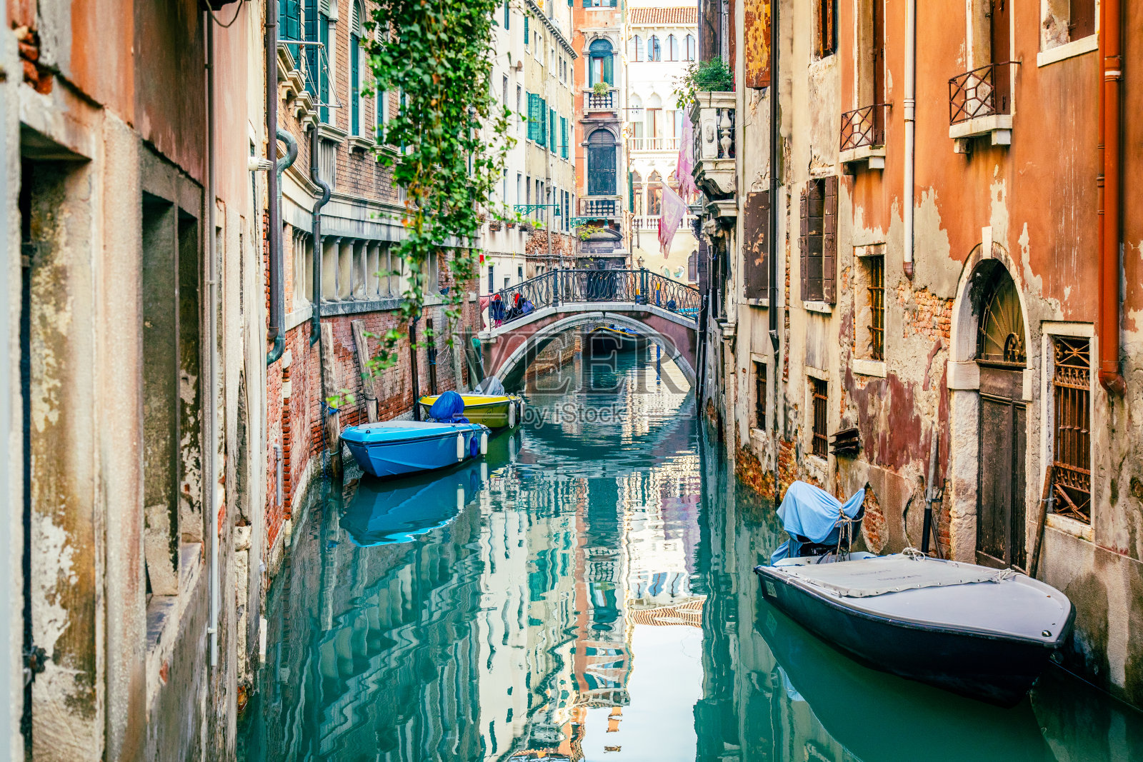 意大利威尼斯的运河，运河上有船只，周围是古老的住宅建筑照片摄影图片