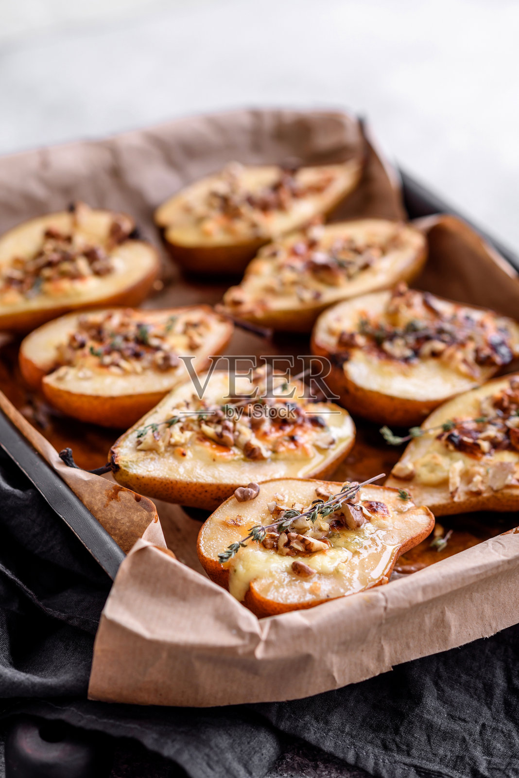 美味的烤梨，多布鲁奶酪，核桃和蜂蜜在纹理混凝土背景照片摄影图片