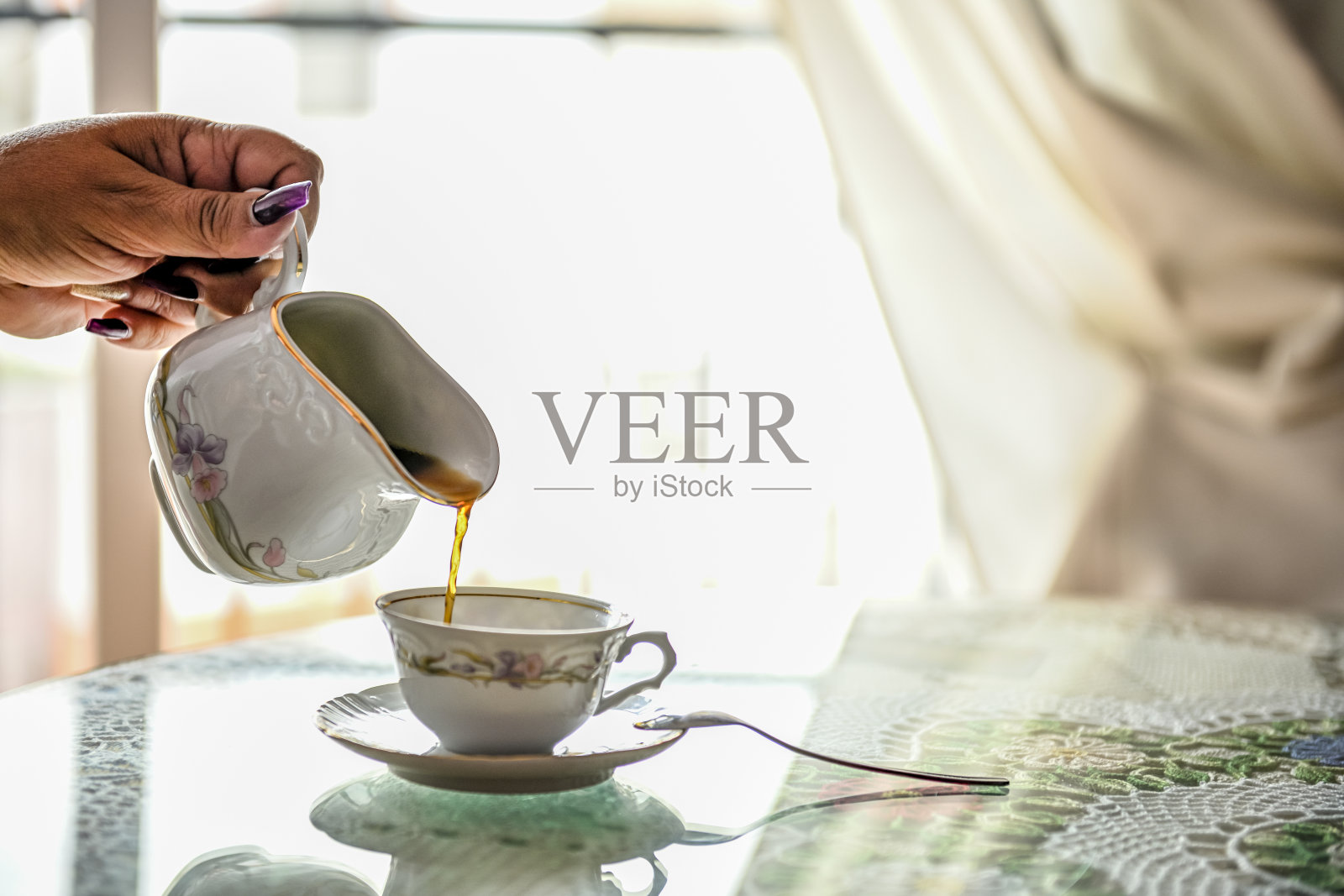 用玻璃杯盛茶，放在桌子上。自然明亮的背景。照片摄影图片