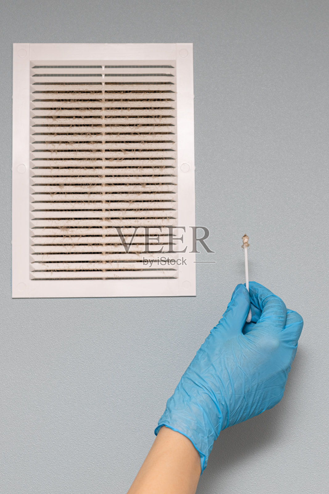 一个人在检查通风格栅的状况。照片摄影图片