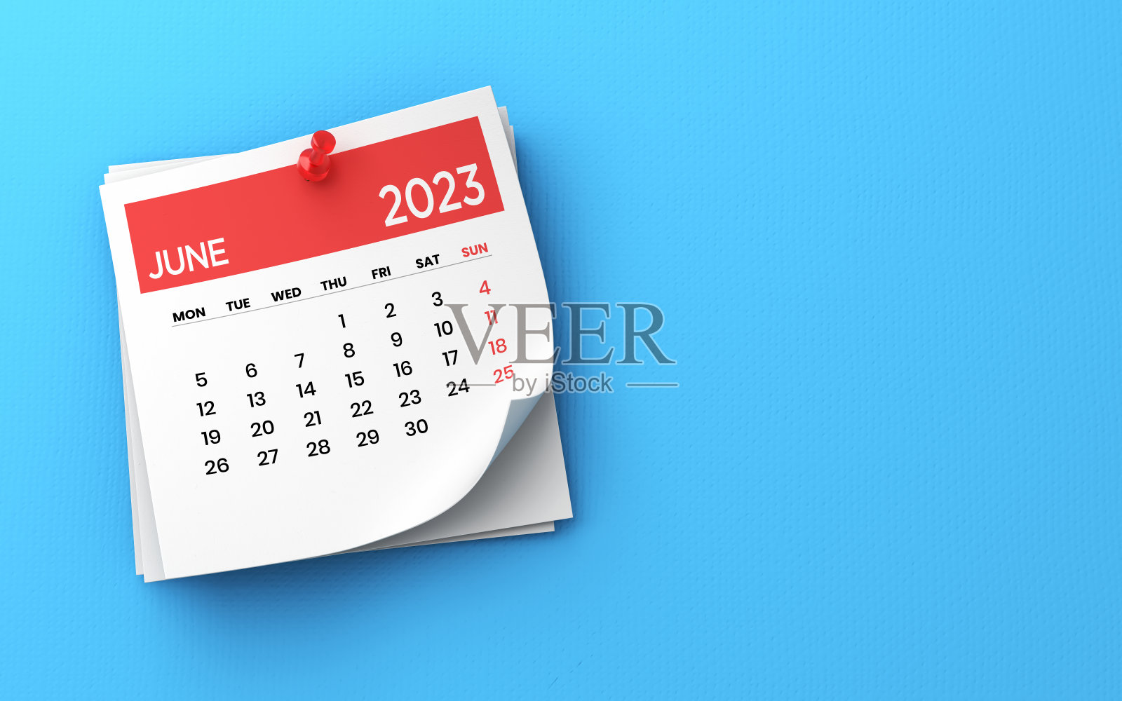 2023年6月日历钉在蓝色背景上照片摄影图片