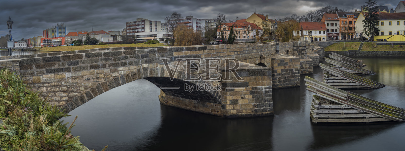 在阴云密布的冬日清晨，古老的石桥和皮塞克镇中心照片摄影图片