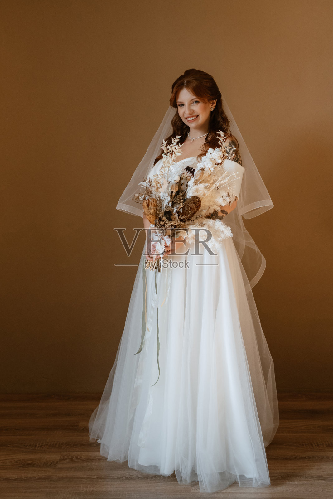 一个穿着白色婚纱的红头发新娘的肖像照片摄影图片