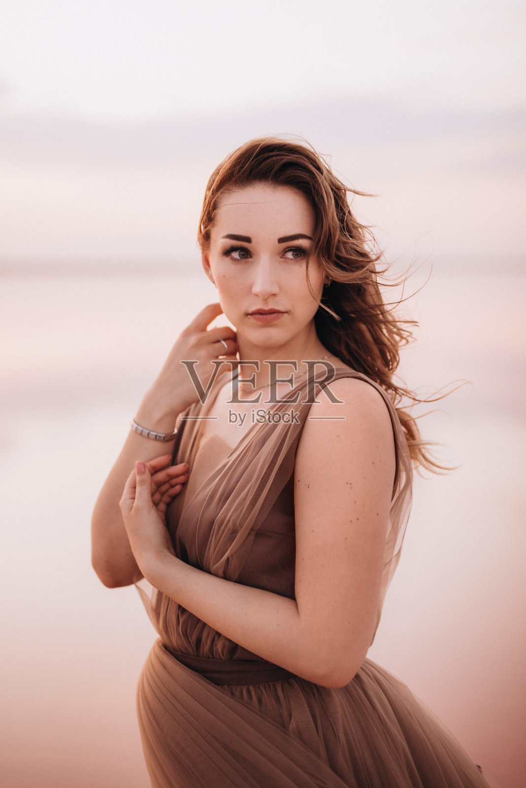 粉色盐湖岸边的女孩照片摄影图片