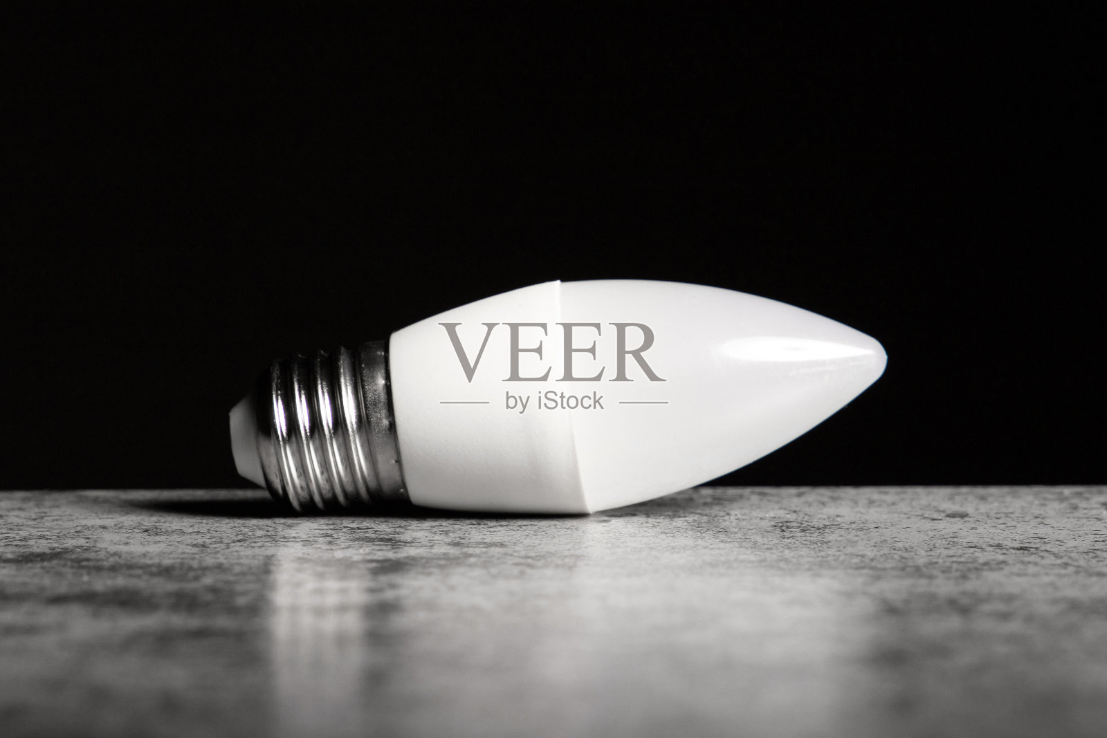 LED节能灯采用E27螺旋帽底座形式的蜡烛，黑色背景，复制空间照片摄影图片