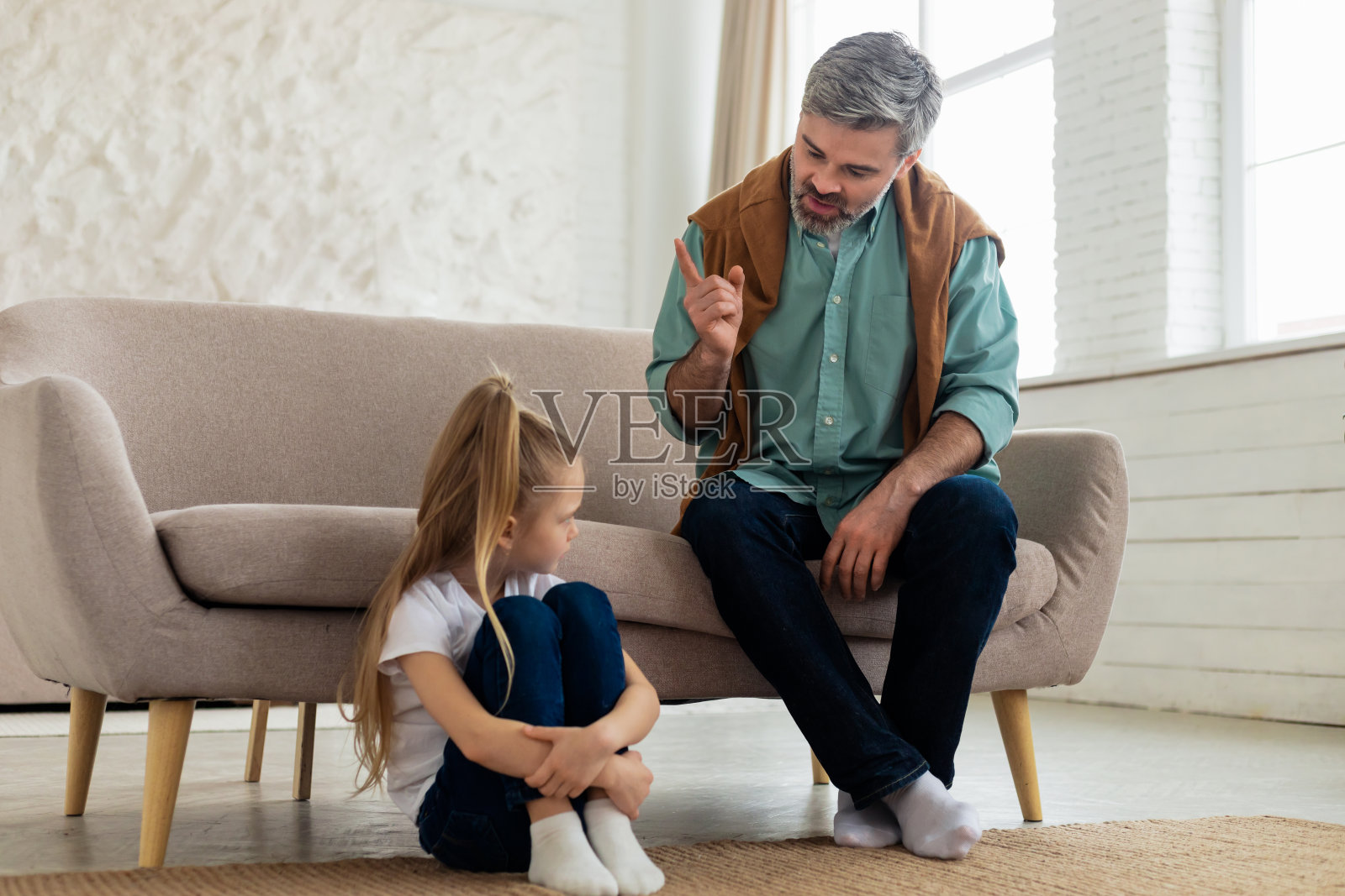 严厉的父亲责骂伤心的女儿在家里的不良行为照片摄影图片