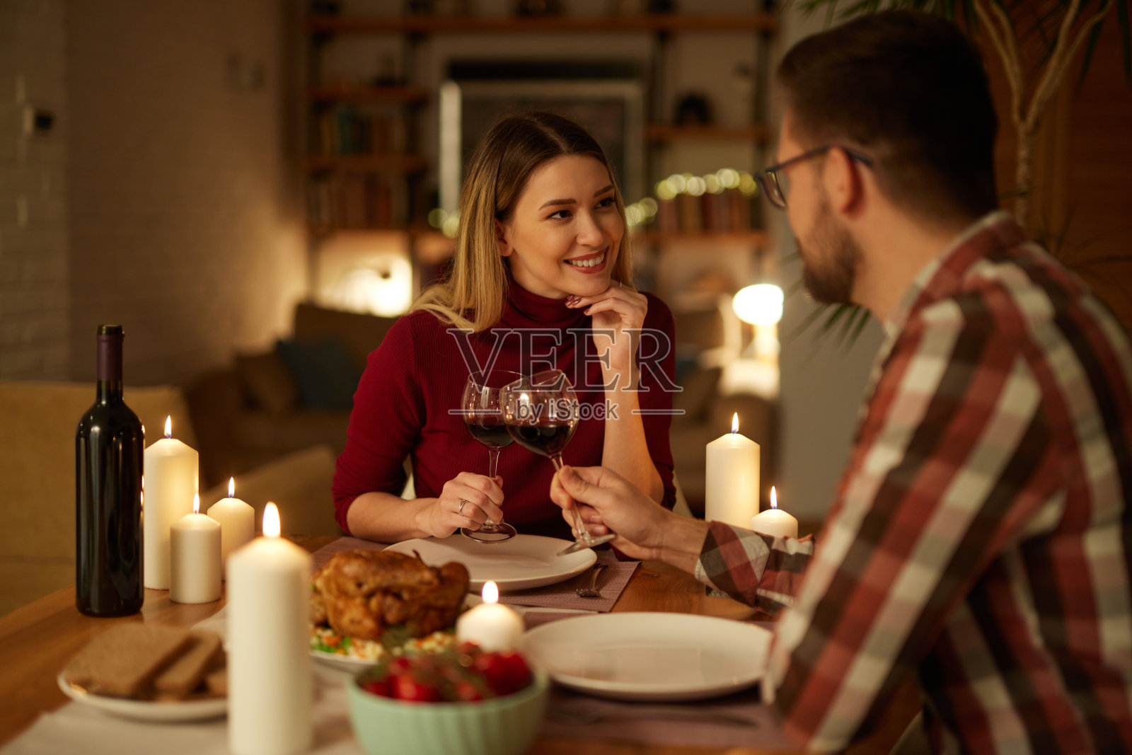 美丽的情侣在家里用蜡烛和红酒共进浪漫的晚餐照片摄影图片