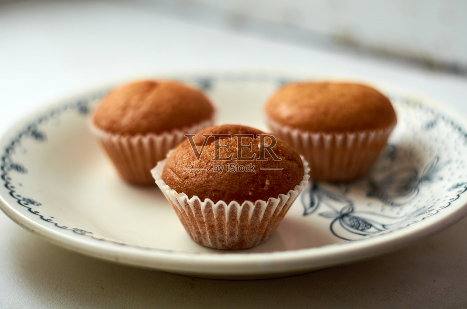 盘子里有三个纸杯蛋糕的照片照片摄影图片