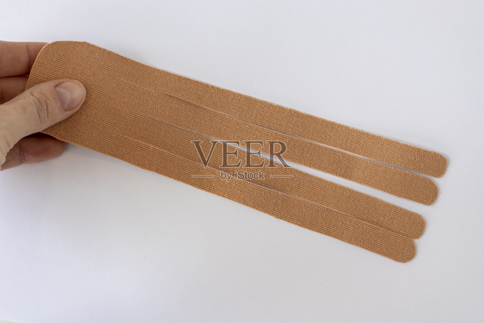 一块白色背景的肌内肌胶带，专门剪下来贴在身体上，平铺照片摄影图片