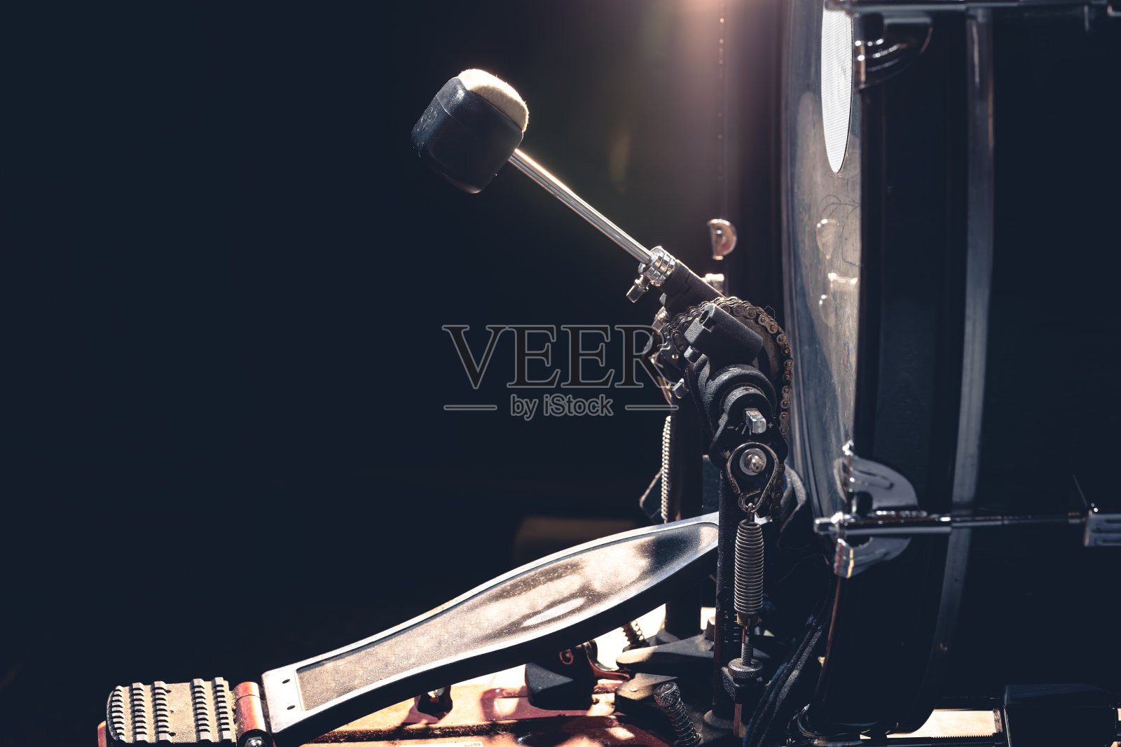 低音鼓与踏板，乐器在黑色背景。照片摄影图片