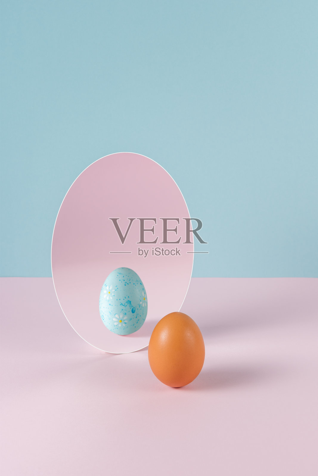 有创意的复活节概念，彩蛋和镜子在粉彩的粉红色和蓝色背景。最小的复活节假期想法。照片摄影图片