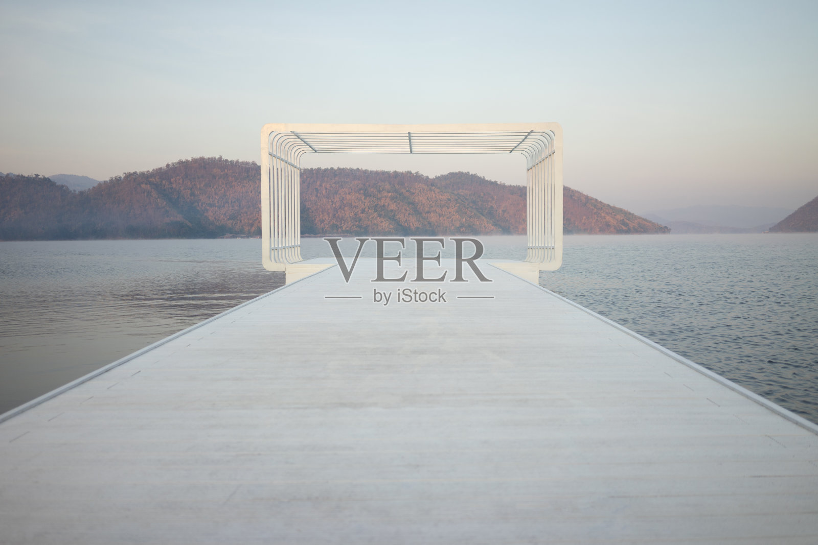 一个大的矩形形状，一个度假胜地的观点，周围有山和水，微雾照片摄影图片