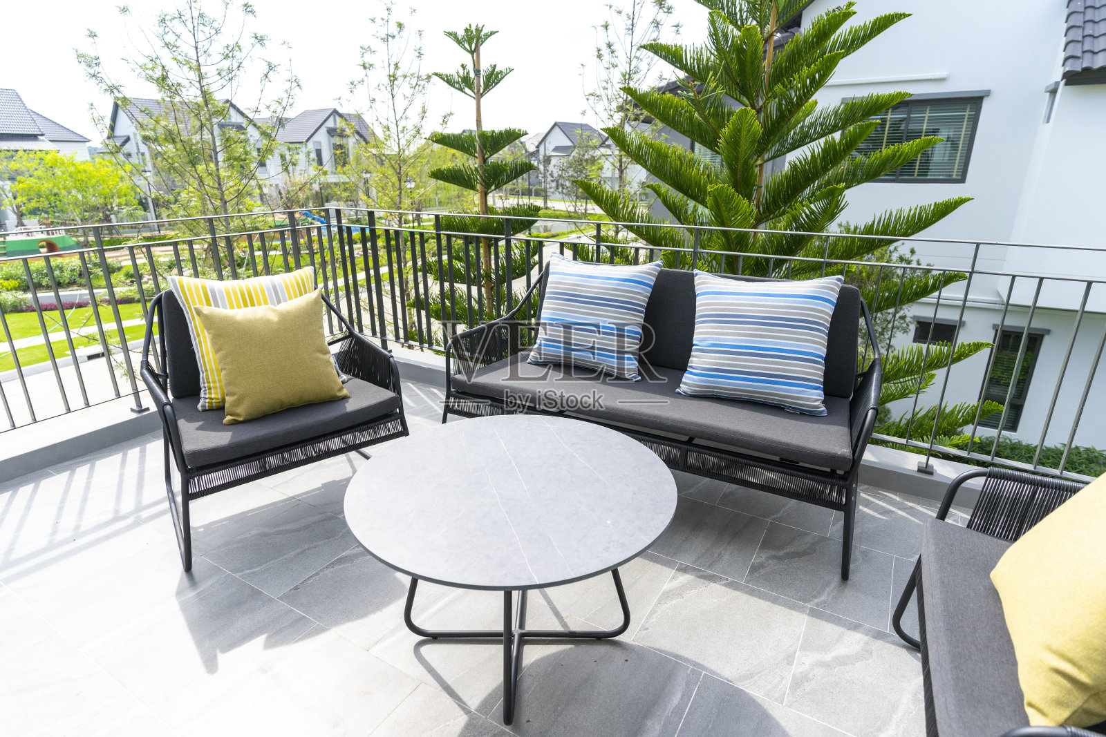 现代户外沙发，桌子和舒适的枕头在私人门廊。照片摄影图片