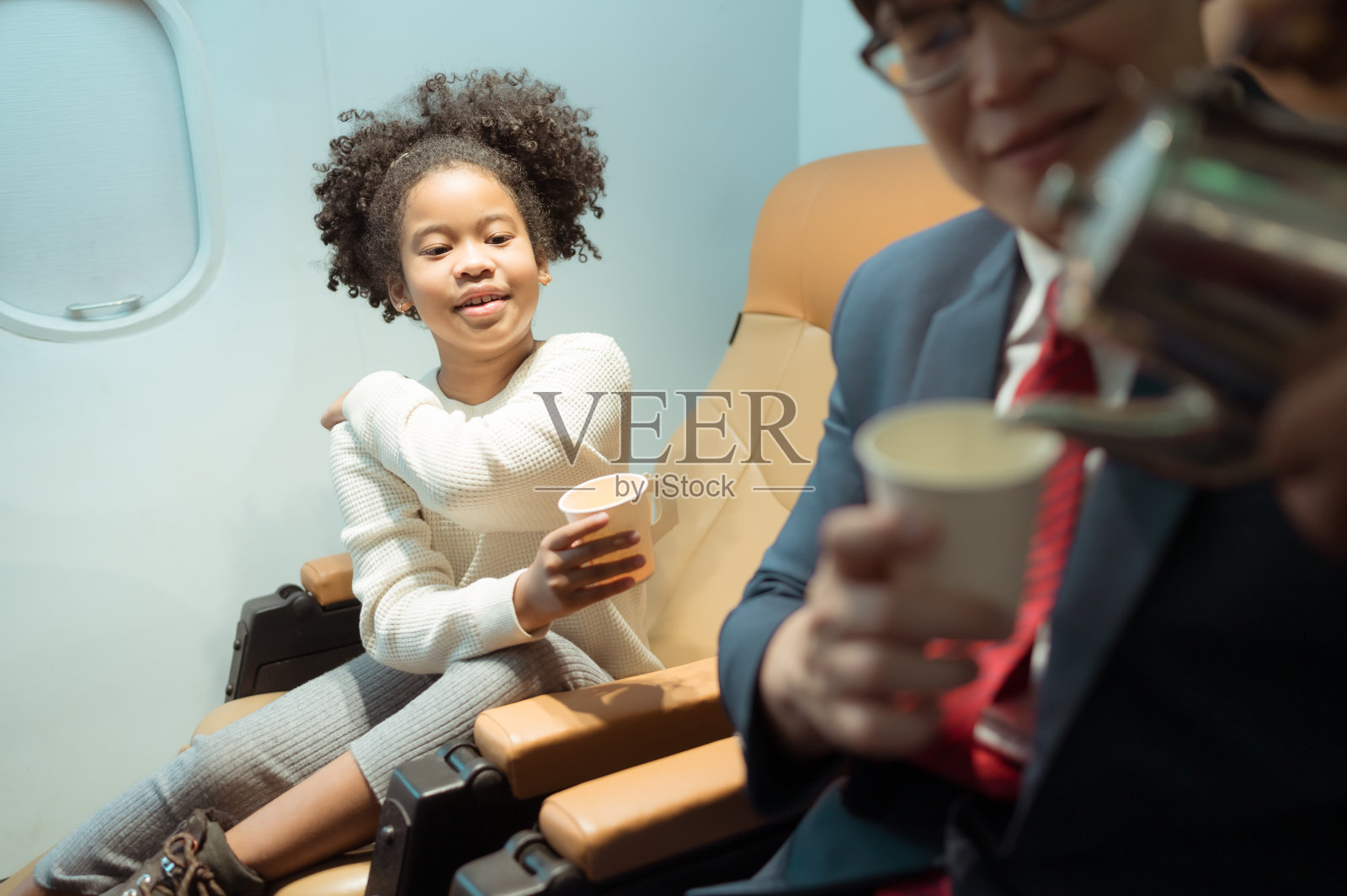 空乘人员为商务舱乘客提供饮料照片摄影图片