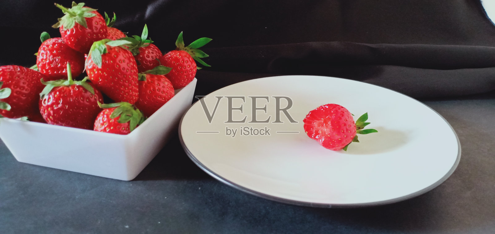 草莓是红色的，吃起来很甜。看起来真不错。照片摄影图片