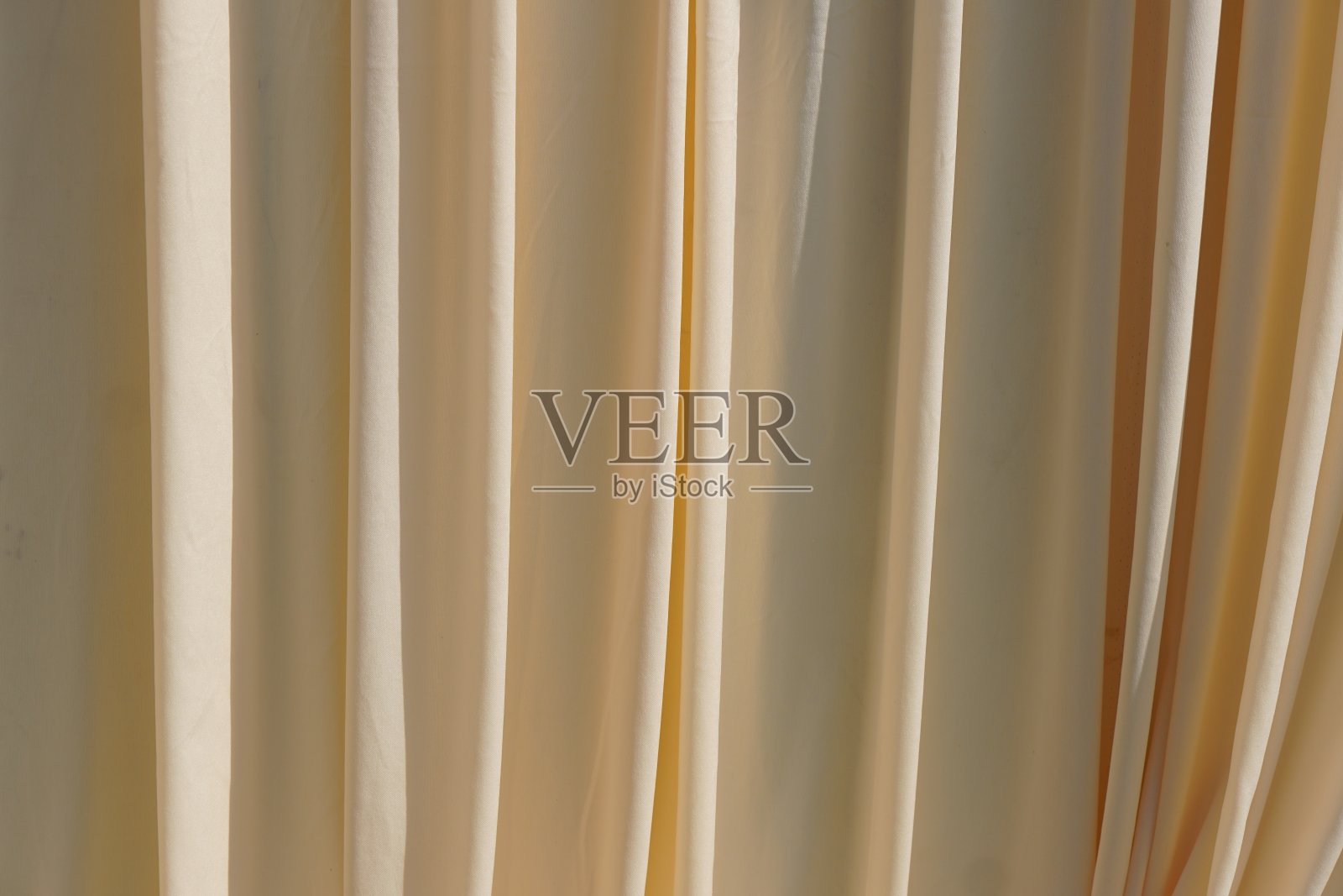 黄色窗帘排成波浪状。照片摄影图片