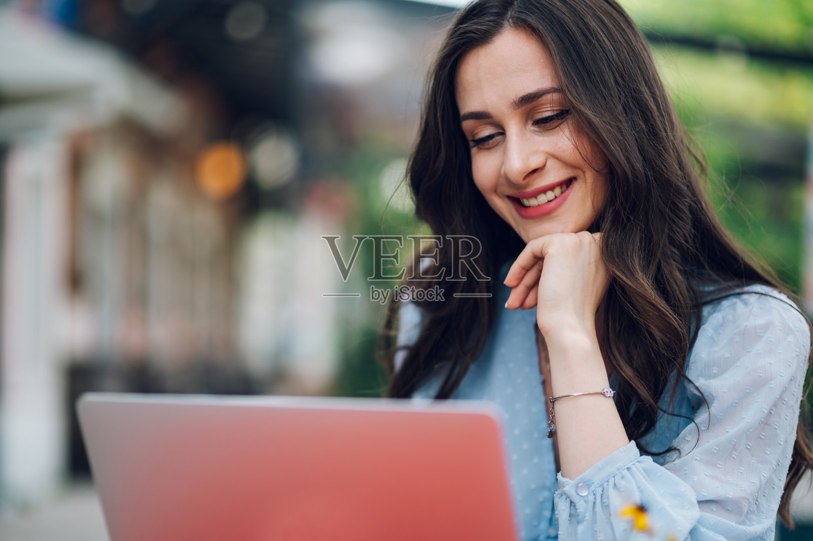 美女坐在街边咖啡馆里用笔记本电脑照片摄影图片