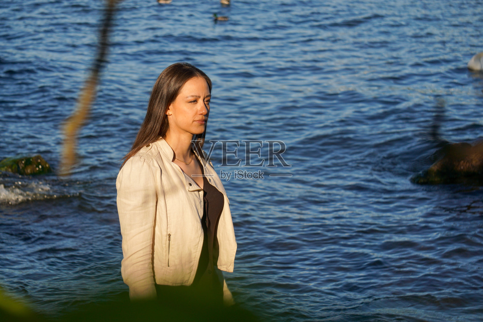 夏天，年轻女子站在湖边照片摄影图片