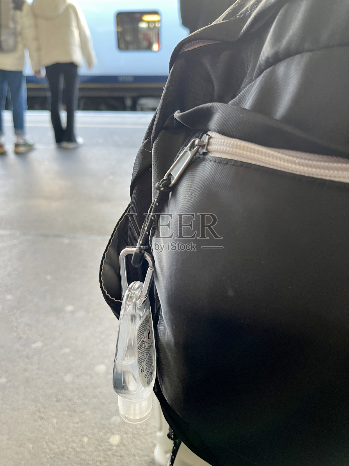 火车站旅行包上的迷你洗手液照片摄影图片