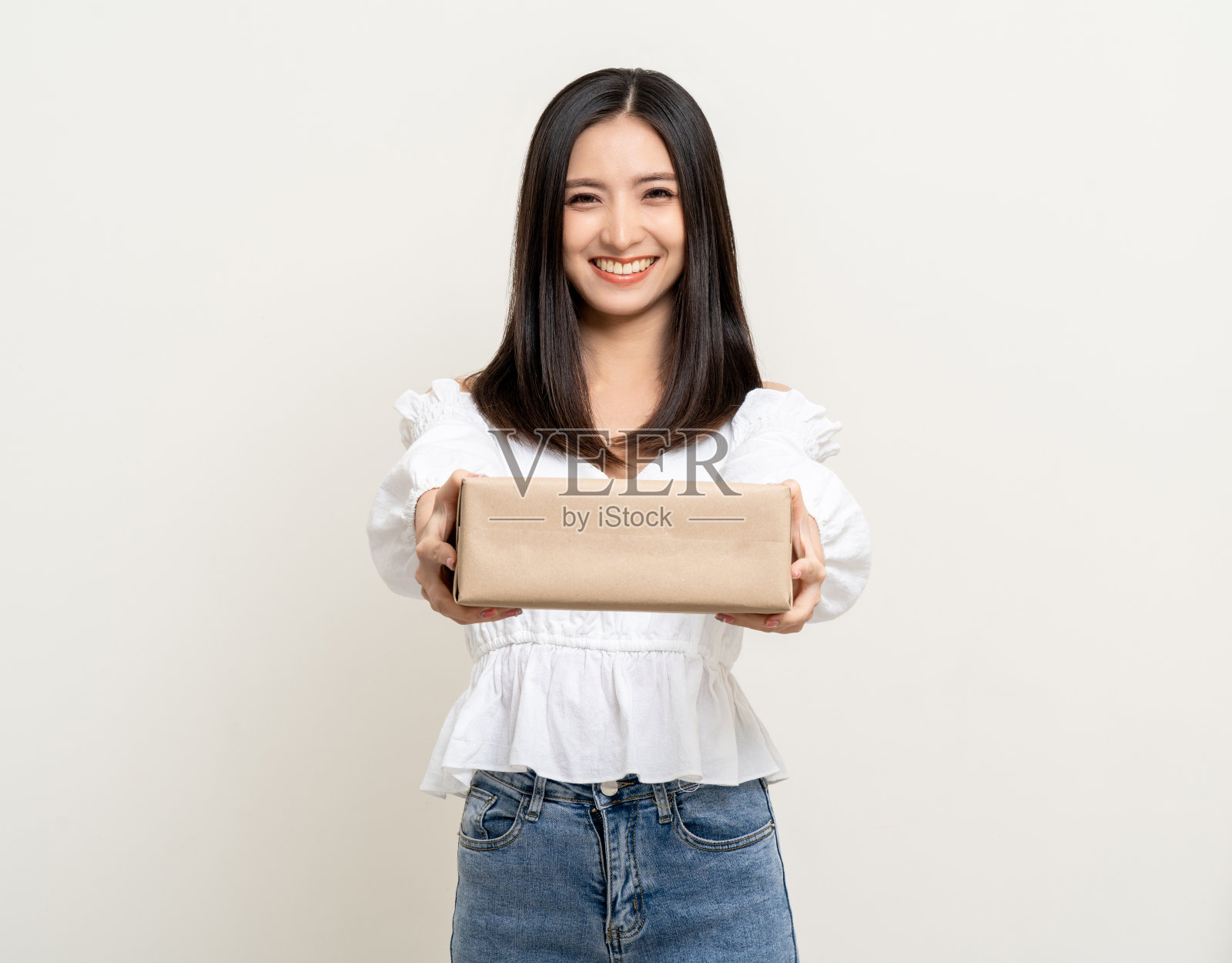 年轻兴奋美丽的亚洲女人包裹纸板站在孤立的背景。快乐的女子抱着许多包裹盒子从快递公司收到网上购物申请照片摄影图片