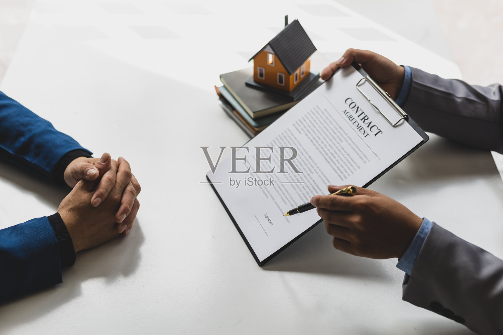 房地产经纪人正在讨论和解释购房合同的条款。商人签订合同协议，抵押，租房，租赁，房屋保险。照片摄影图片